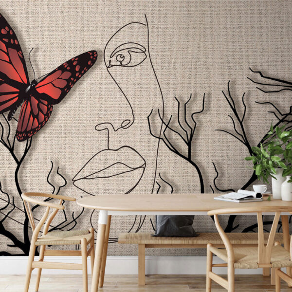 Una mariposa y el dibujo de la cara de una mujer Una mariposa y el dibujo de la cara de una mujer