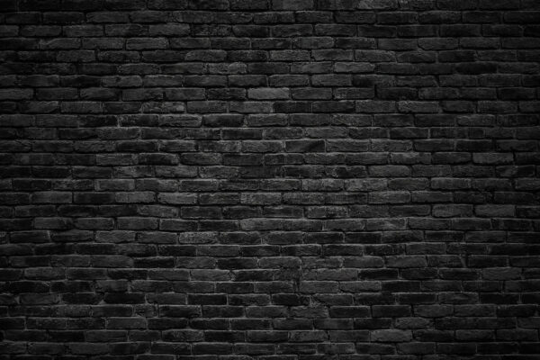 Pared de ladrillo negro con una mancha blanca Pared de ladrillo negro con una mancha blanca