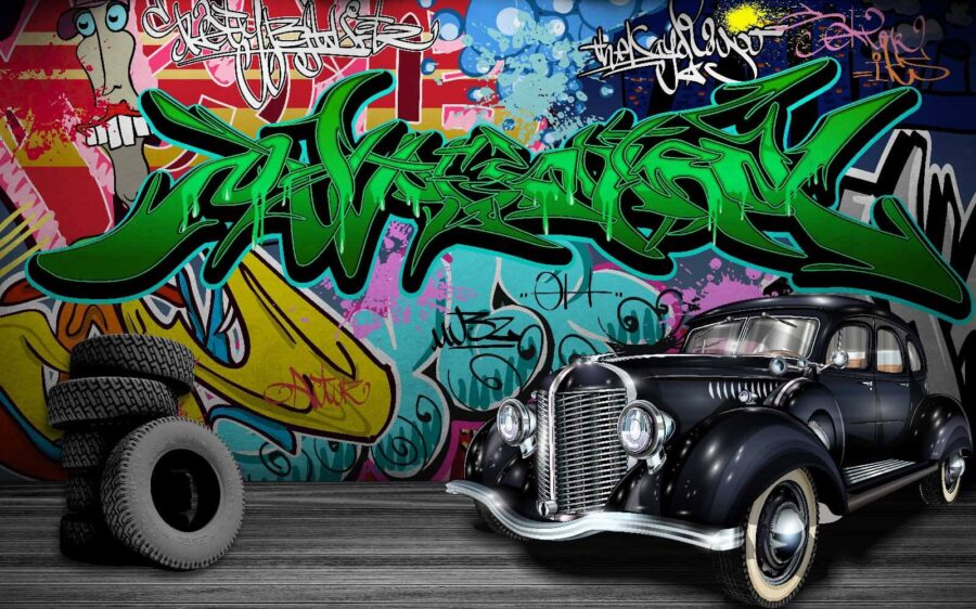 Coche negro con ruedas delante de una pared colorida Coche negro con ruedas delante de una pared colorida