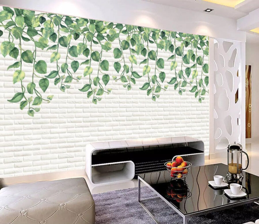 Pared de ladrillo blanco con hojas verdes