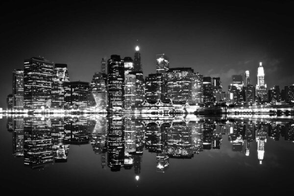 El horizonte de la ciudad de noche con luces reflejándose en el agua El horizonte de la ciudad de noche con luces reflejándose en el agua