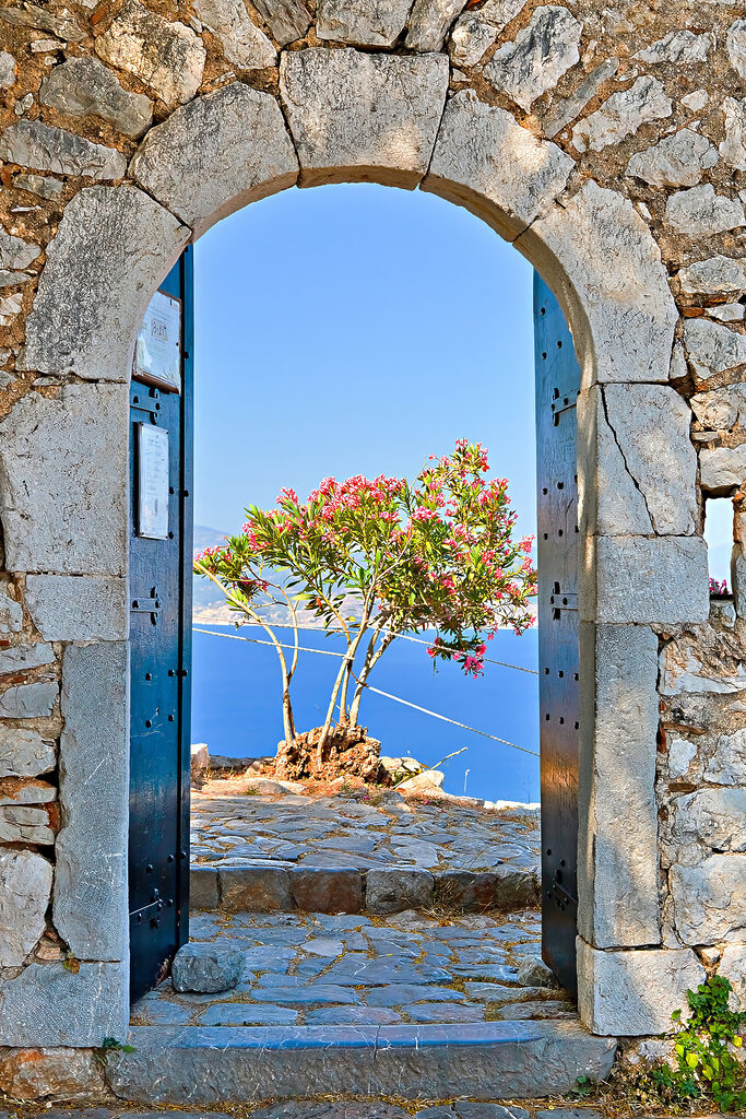 A stone arch with a tree in the background