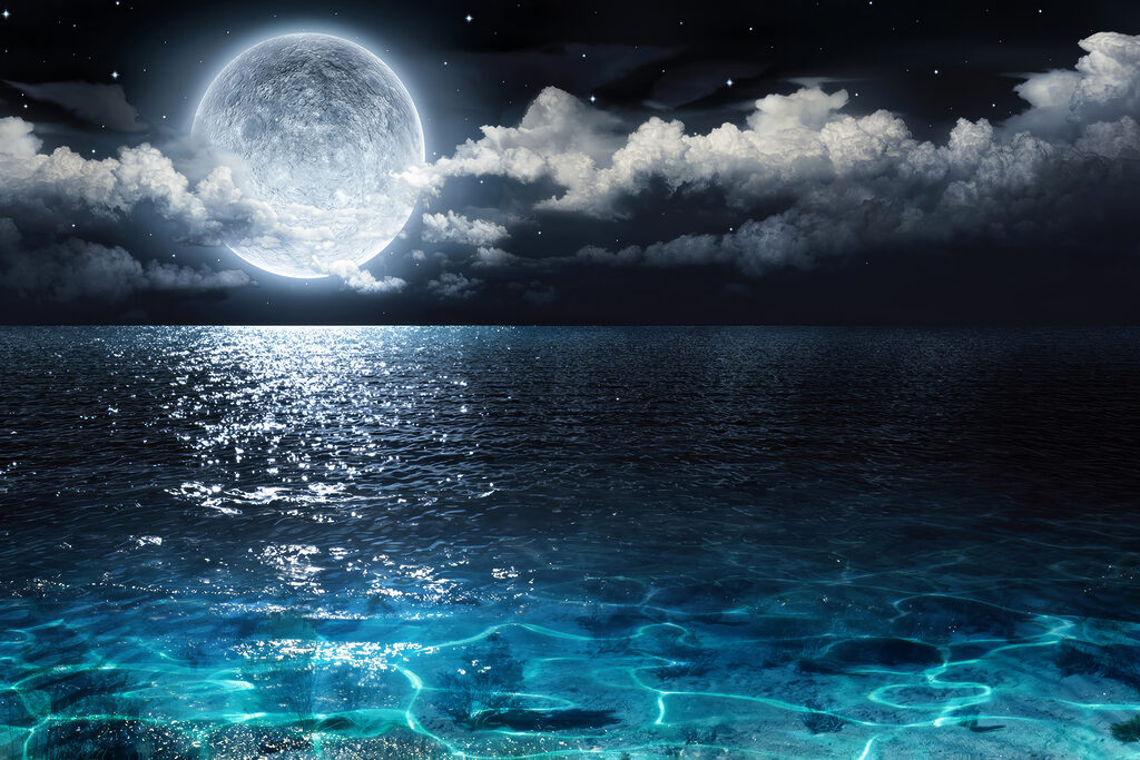 A moon over water at night A moon over water at night