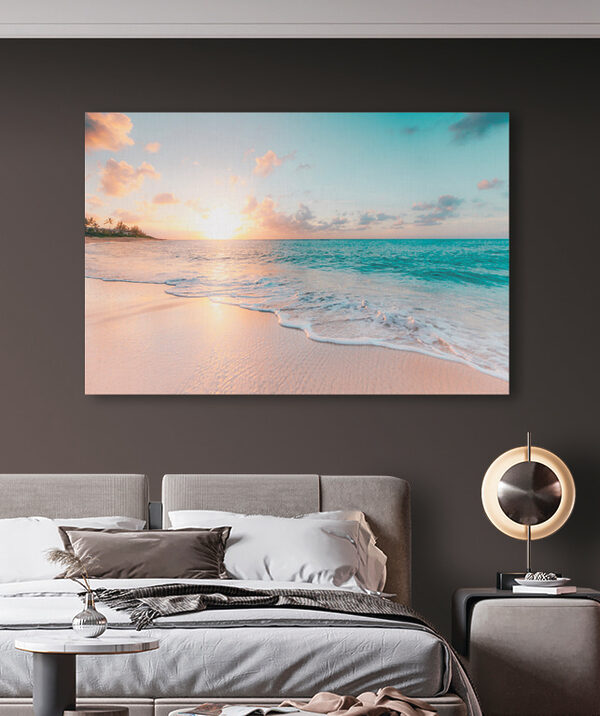 A beach with waves and a sunset
