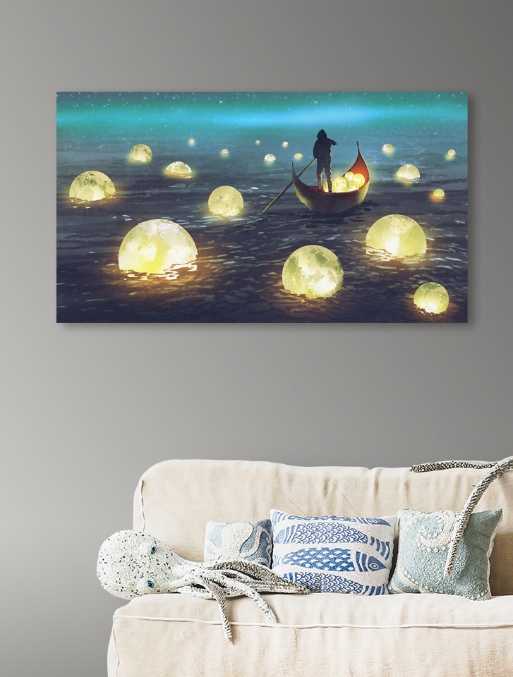 A person in a boat with glowing balls floating in the water A person in a boat with glowing balls floating in the water
