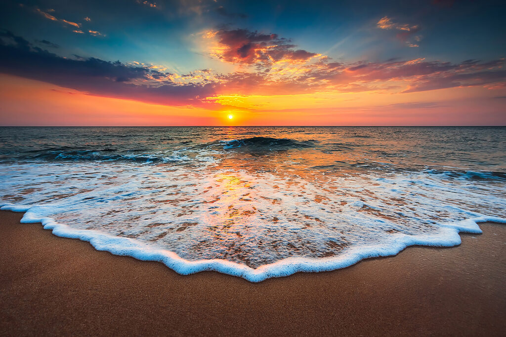 A sunset over a beach A sunset over a beach