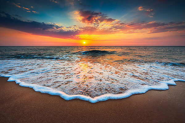 A sunset over a beach A sunset over a beach