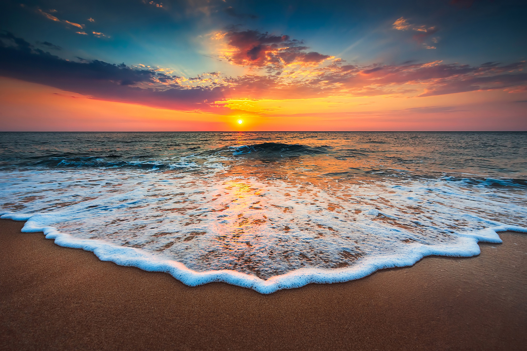 A sunset over a beach A sunset over a beach