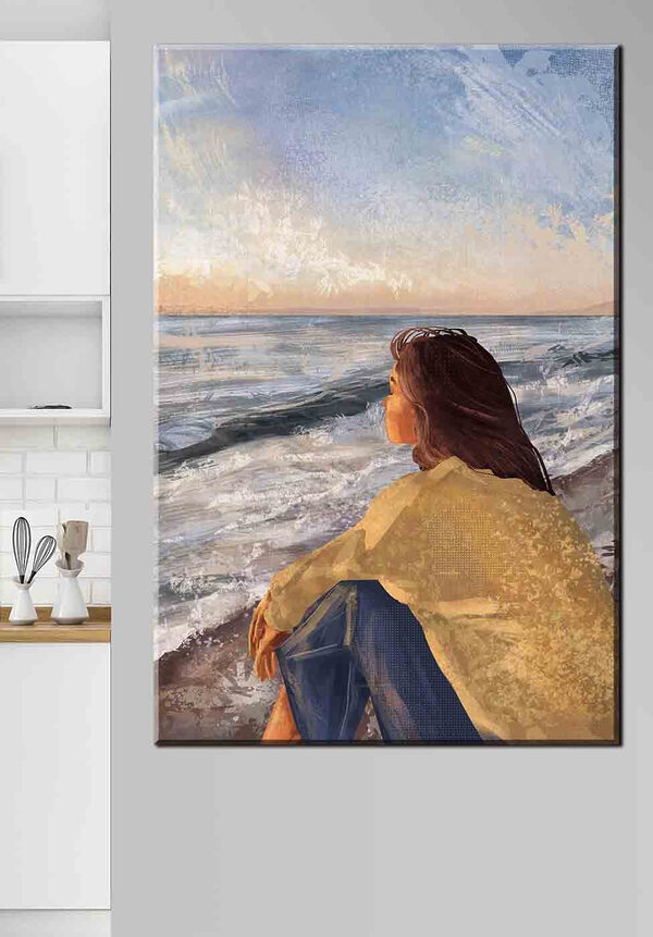 Cuadros Una mujer sentada en la playa contemplando el océano