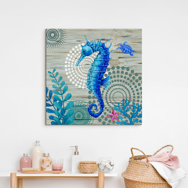 A blue seahorse and seaweed on a wood surface A blue seahorse and seaweed on a wood surface