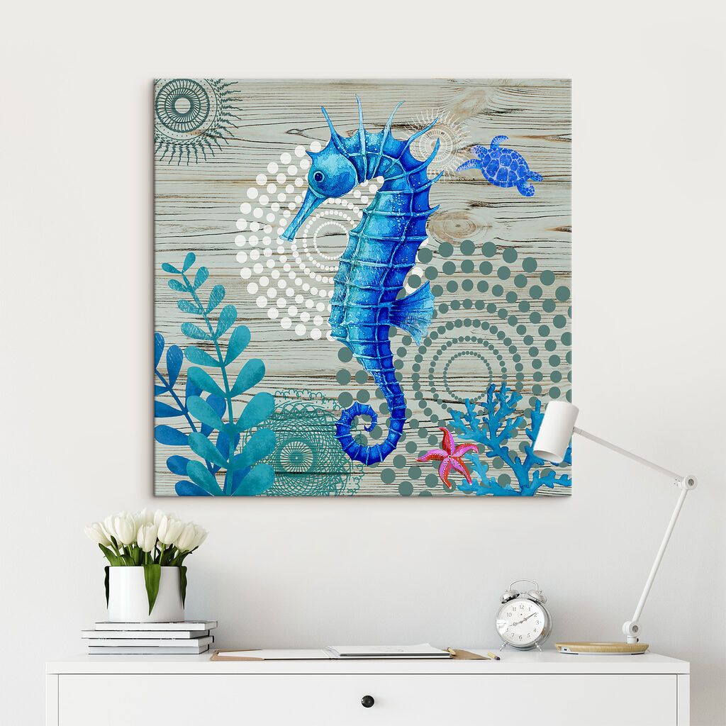 A blue seahorse and seaweed on a wood surface A blue seahorse and seaweed on a wood surface