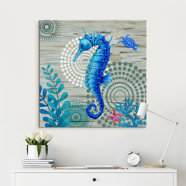 A blue seahorse and seaweed on a wood surface A blue seahorse and seaweed on a wood surface