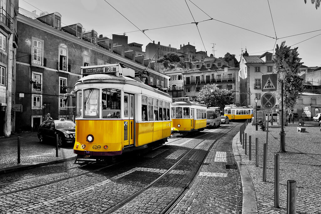 A yellow trolleys on a street