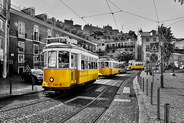 A yellow trolleys on a street