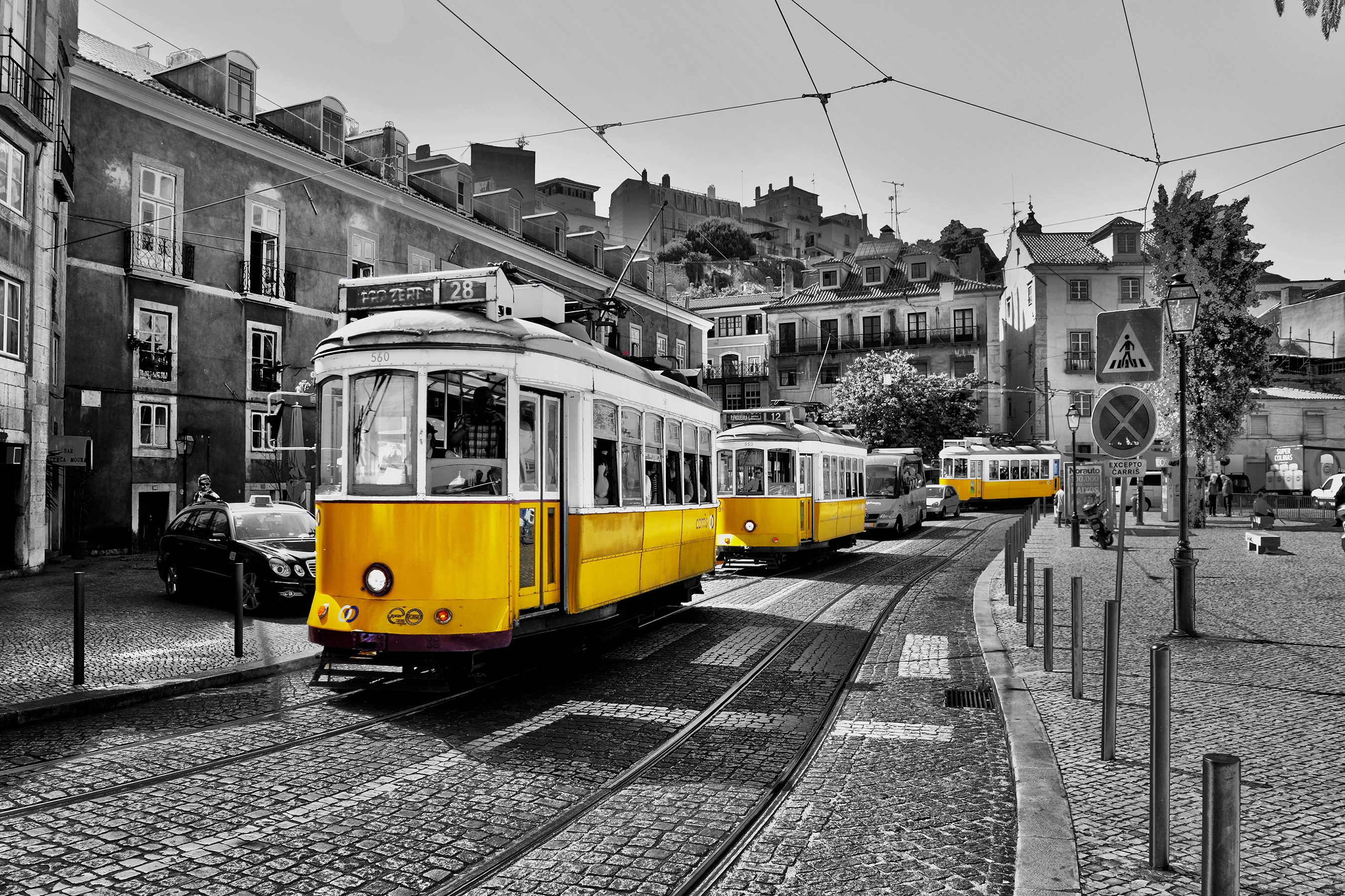 A yellow trolleys on a street