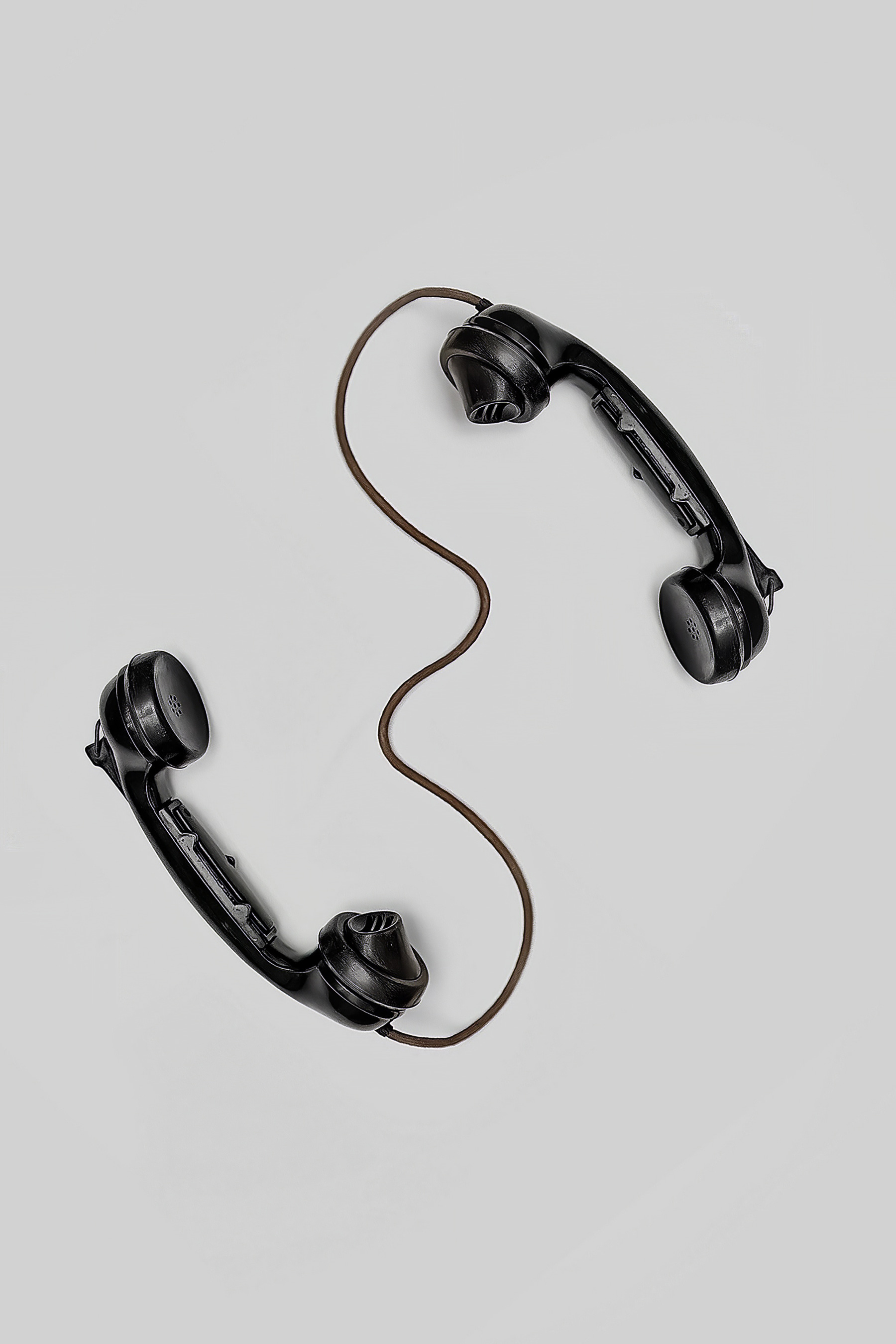 A pair of handsets with a cord
