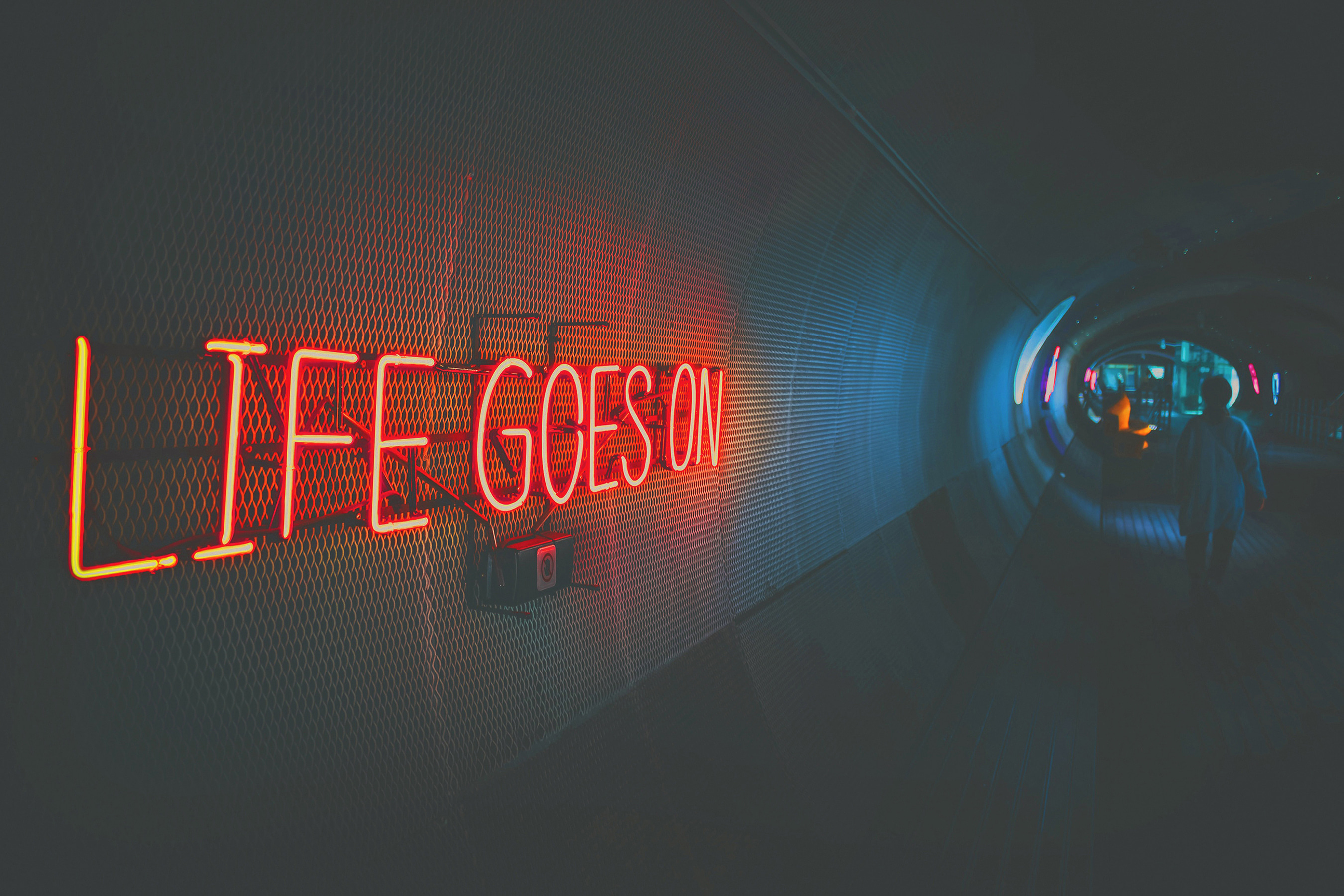 A neon sign in a tunnel