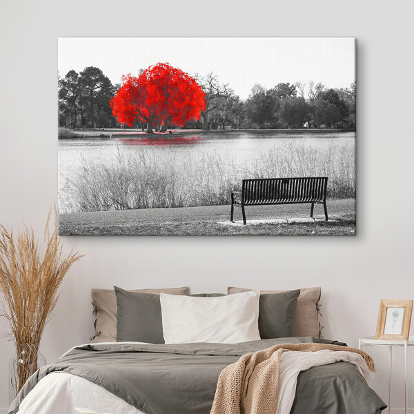 A bench by a lake with a red tree A bench by a lake with a red tree