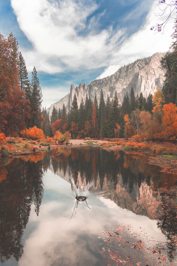 A lake surrounded by trees and mountains