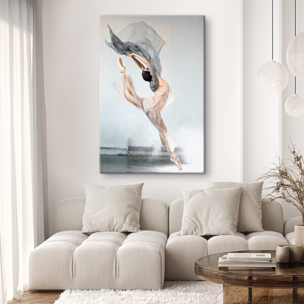 A woman in a dress and pointe shoes jumping in the air