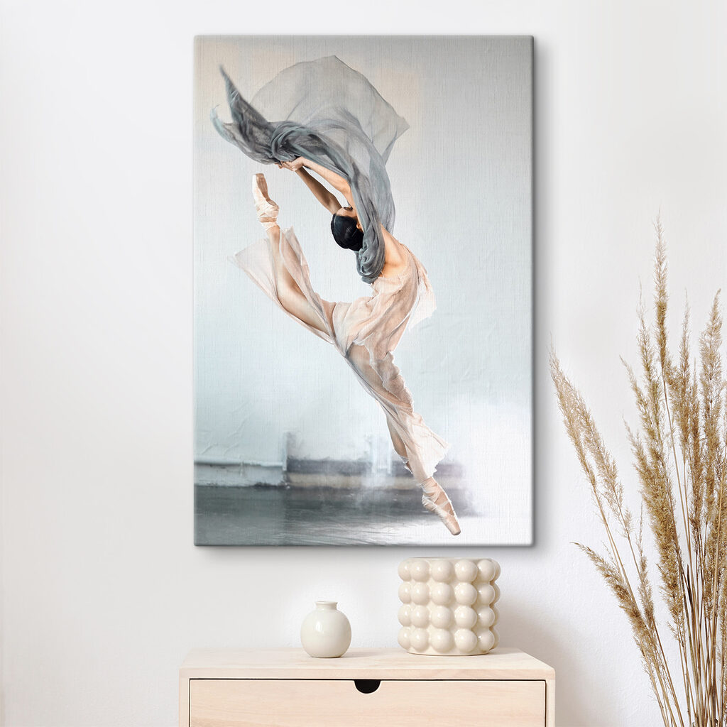 A woman in a dress and pointe shoes jumping in the air