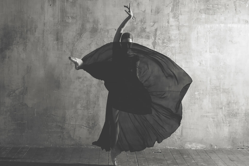 A woman dancing in a black dress