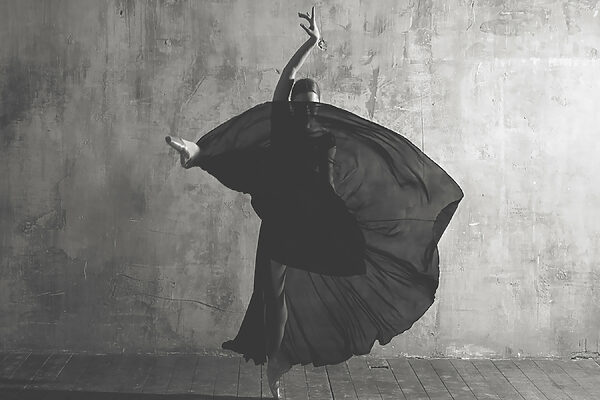 A woman dancing in a black dress