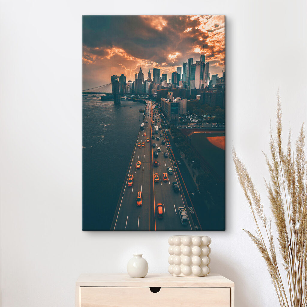 A bridge over water with cars and buildings in the background A bridge over water with cars and buildings in the background