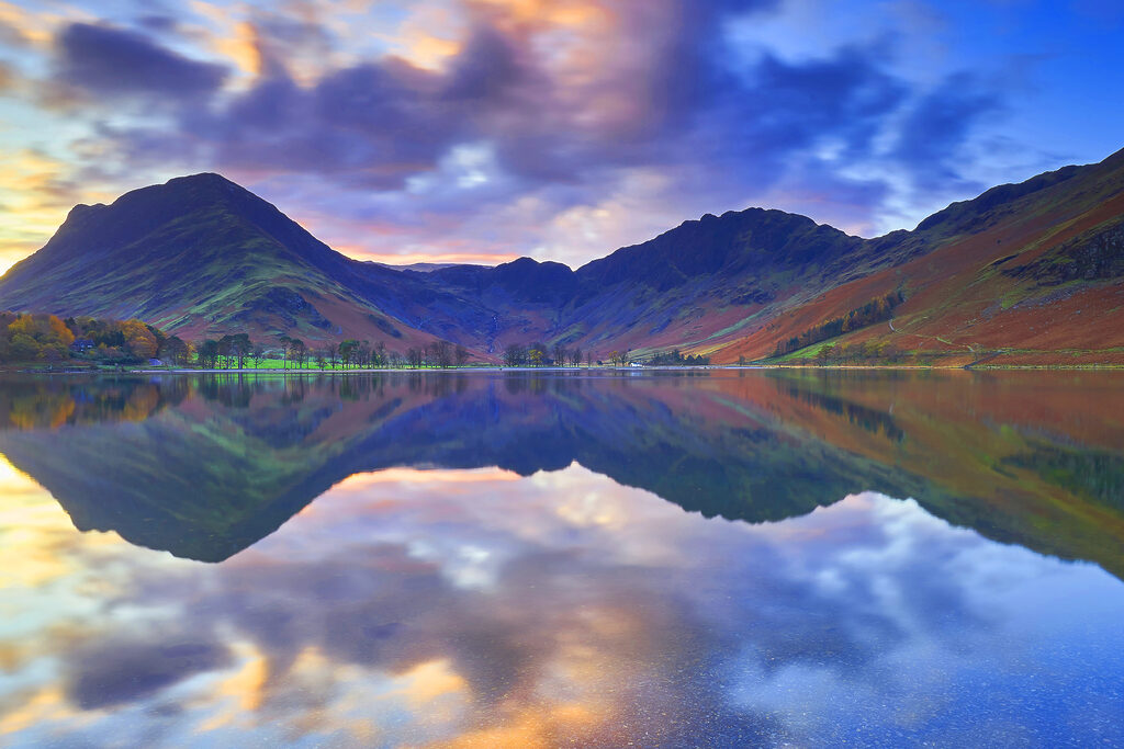A lake with mountains in the background