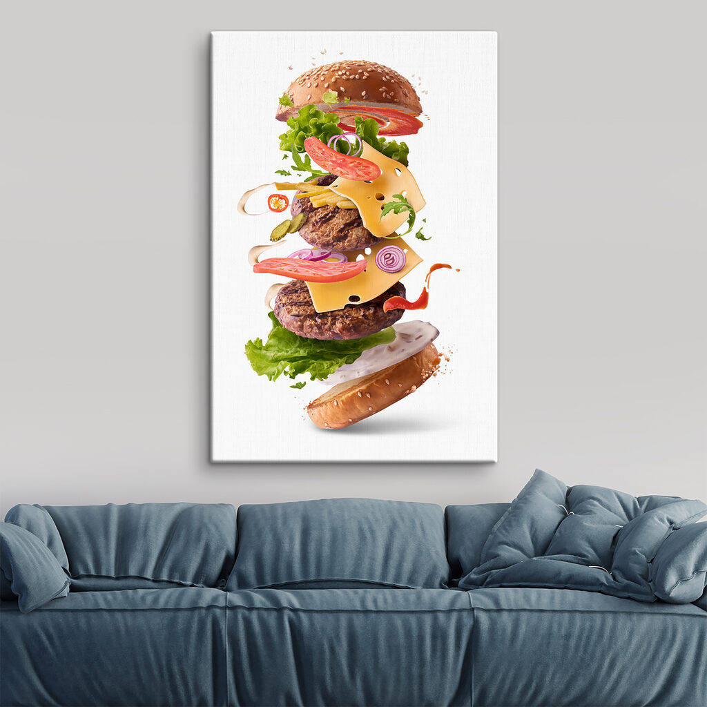 A hamburger with meat and vegetables flying in the air