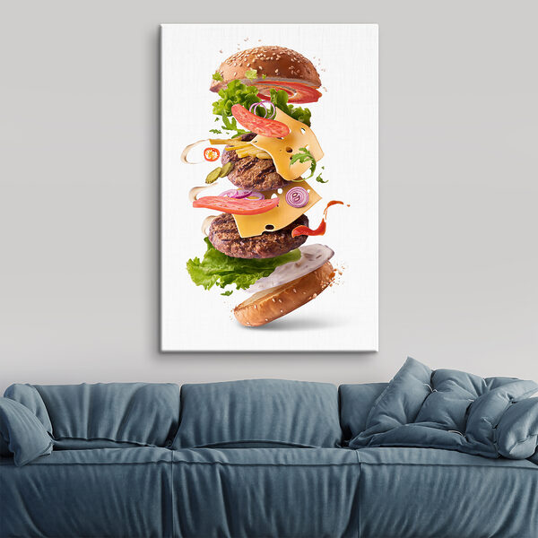 A hamburger with meat and vegetables flying in the air