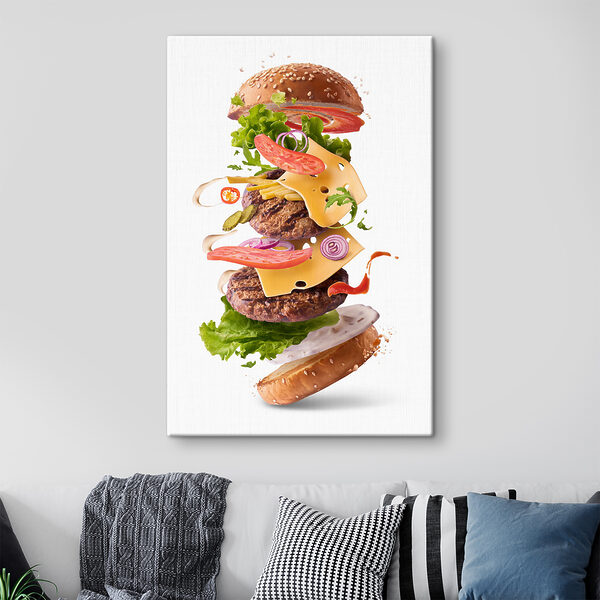A hamburger with meat and vegetables flying in the air