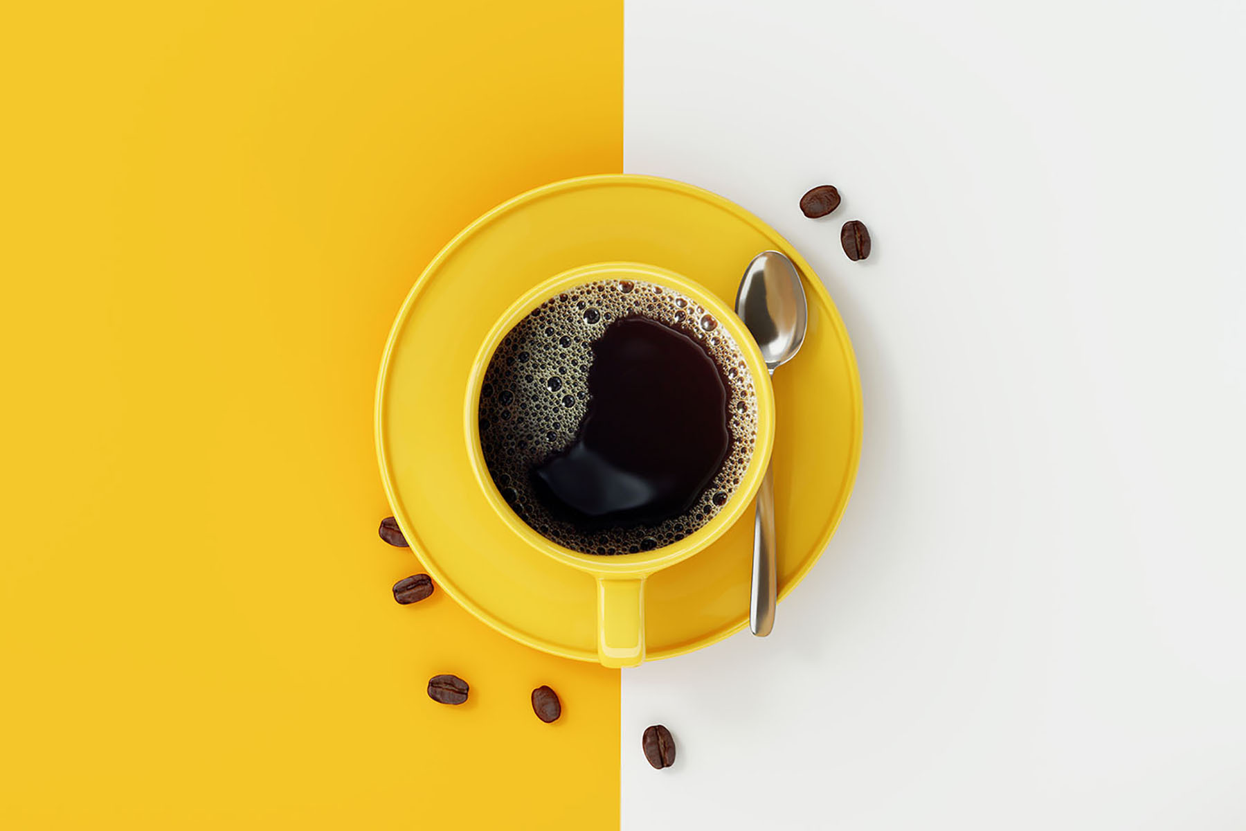 A yellow cup of coffee and beans