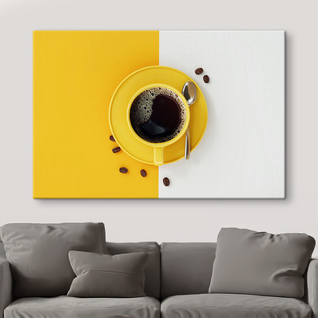 A yellow cup of coffee and beans