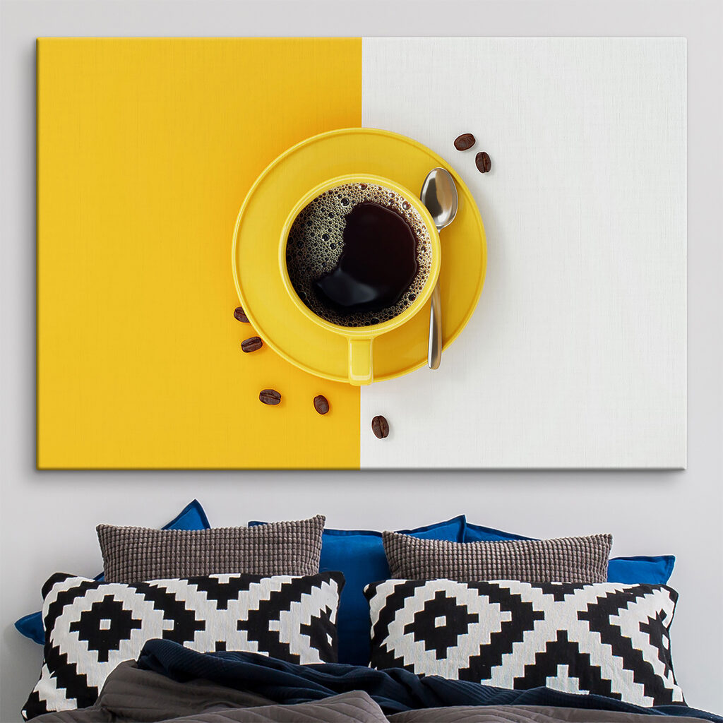 A yellow cup of coffee and beans