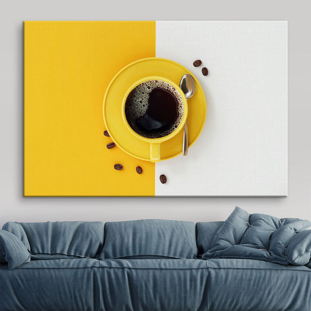 A yellow cup of coffee and beans
