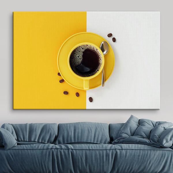 A yellow cup of coffee and beans