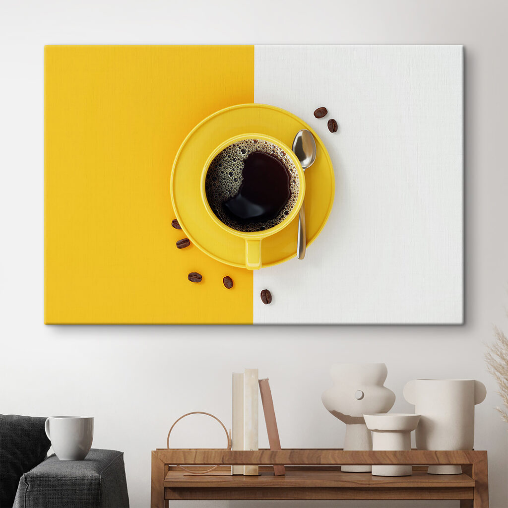 A yellow cup of coffee and beans