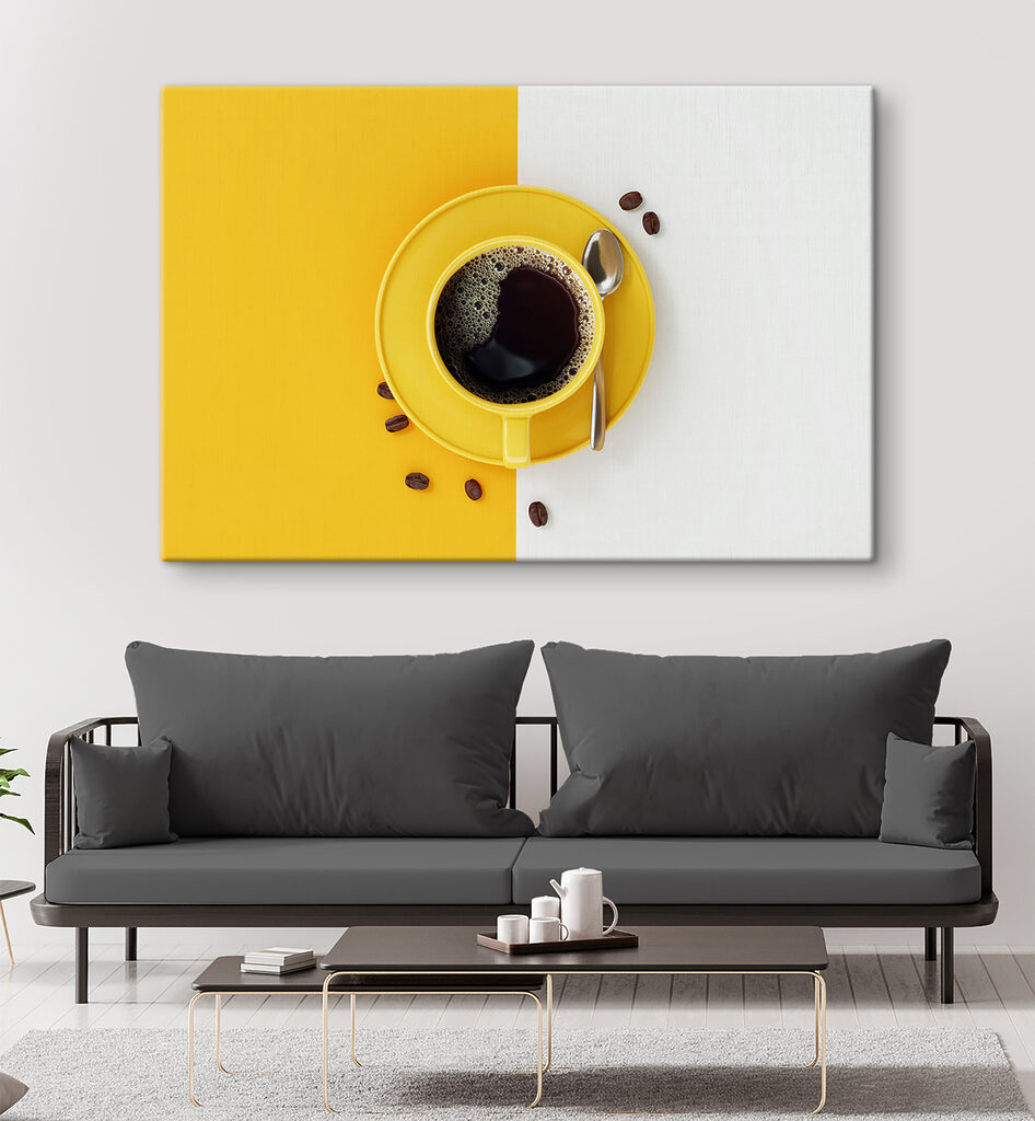 A yellow cup of coffee and beans