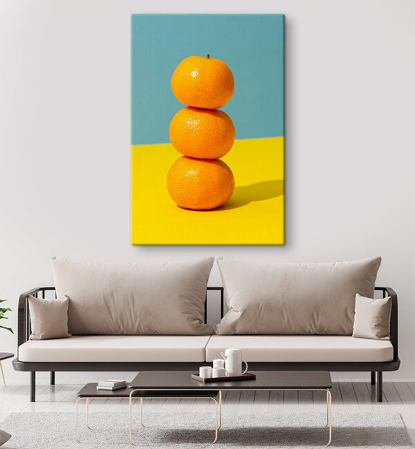 A stack of oranges on a yellow and blue surface