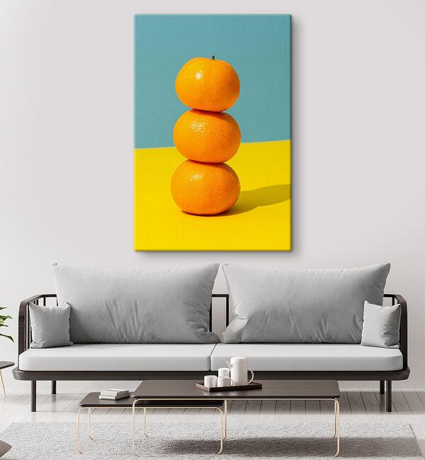 A stack of oranges on a yellow and blue surface