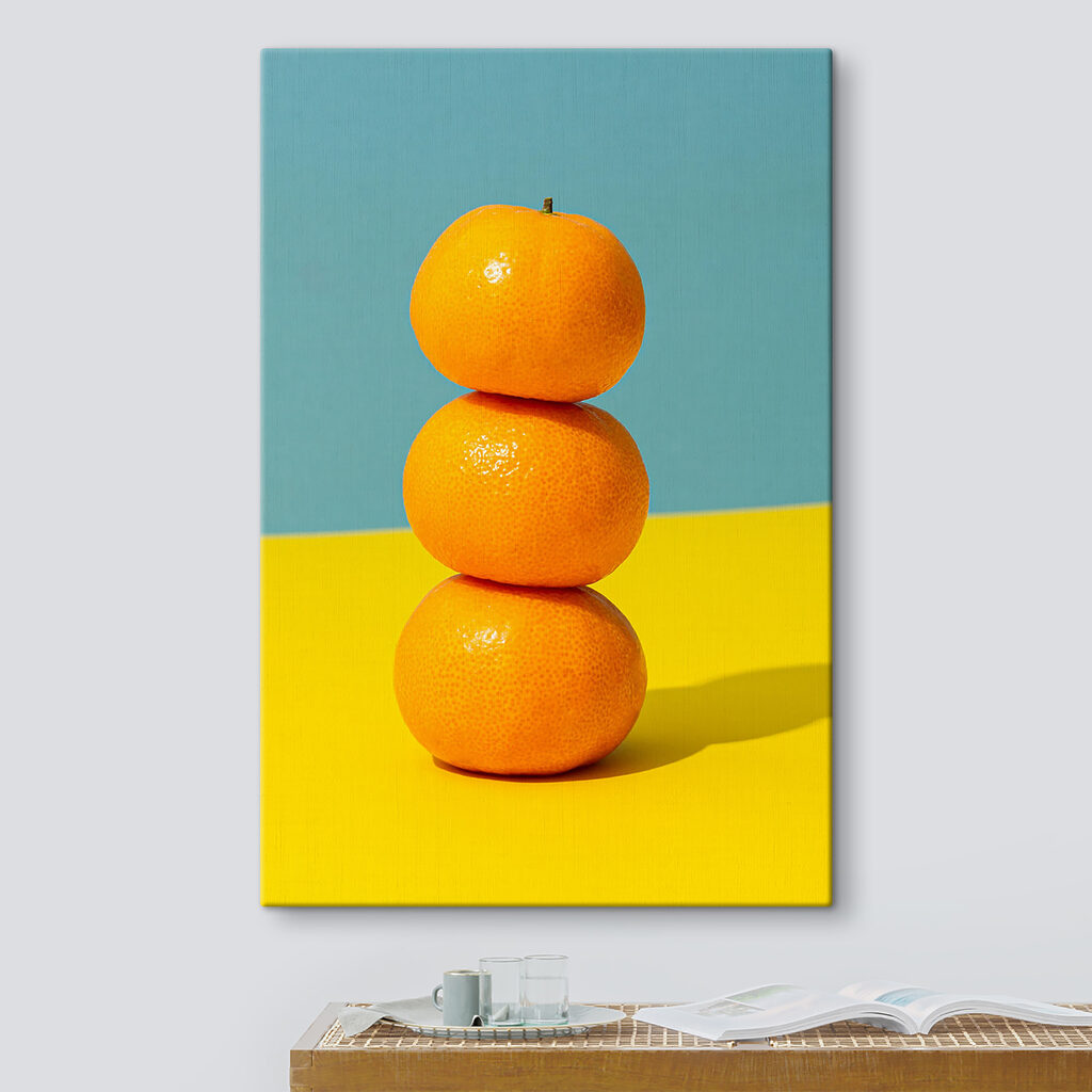 A stack of oranges on a yellow and blue surface