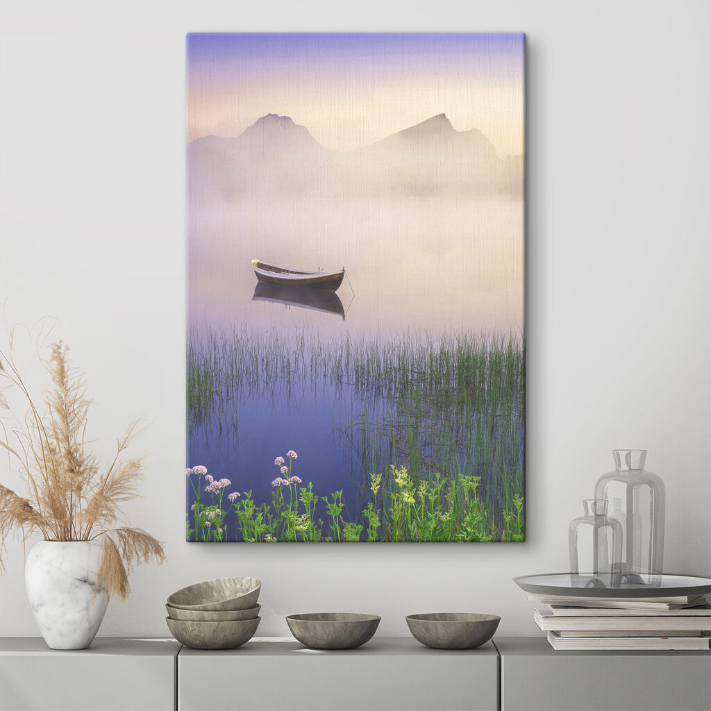 A boat in a lake with grass and mountains in the background A boat in a lake with grass and mountains in the background