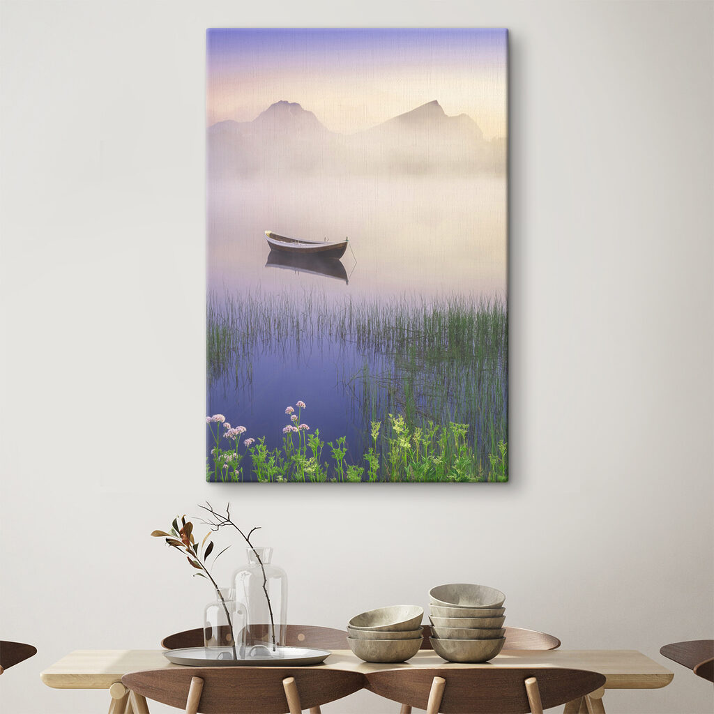 A boat in a lake with grass and mountains in the background A boat in a lake with grass and mountains in the background