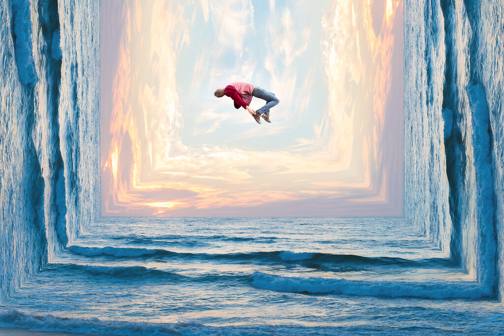 A man jumping in the air over water