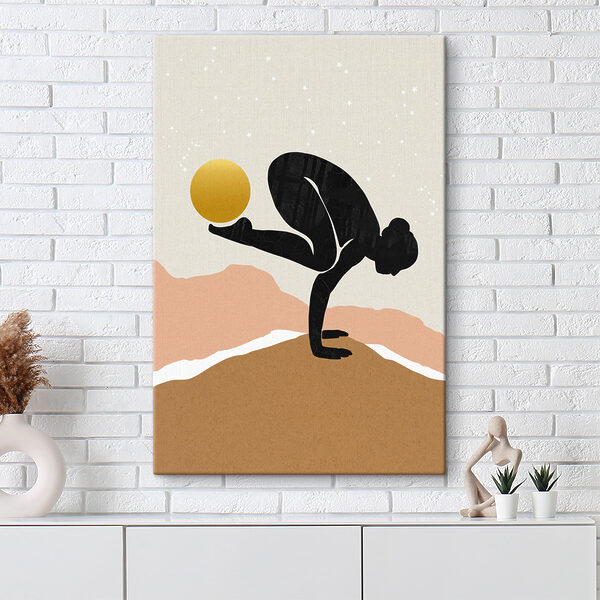 A woman doing a handstand with a yellow ball