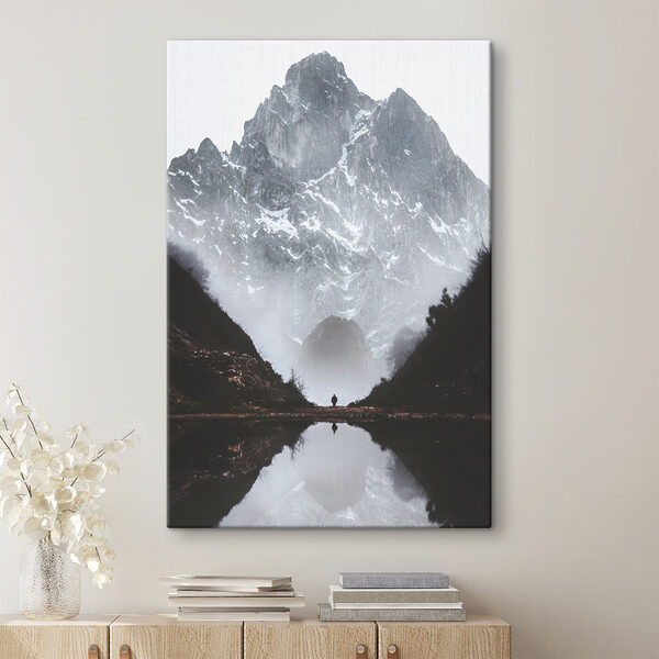 A person standing in a valley with a mountain in the background