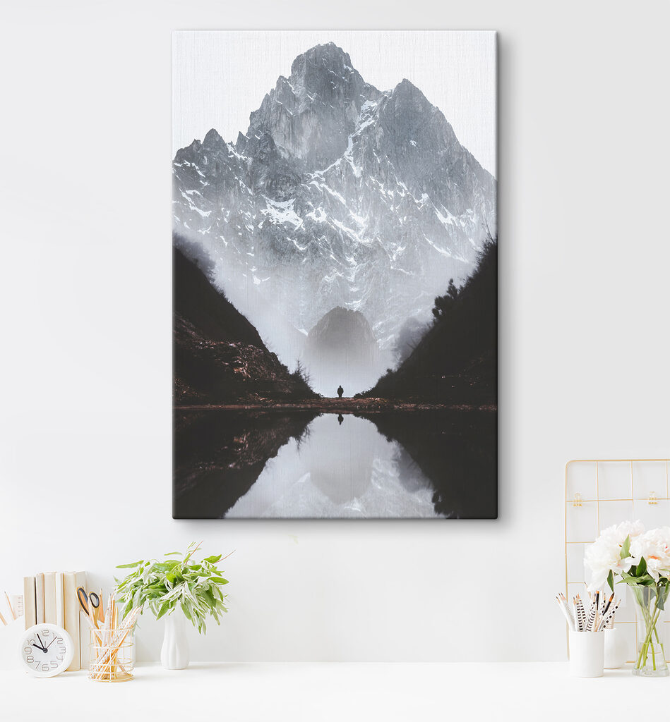 A person standing in a valley with a mountain in the background