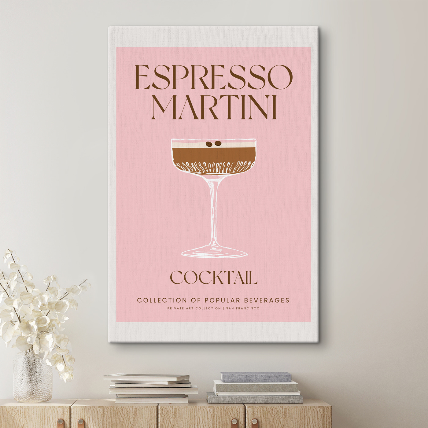 A pink and white sign with a glass of brown liquid