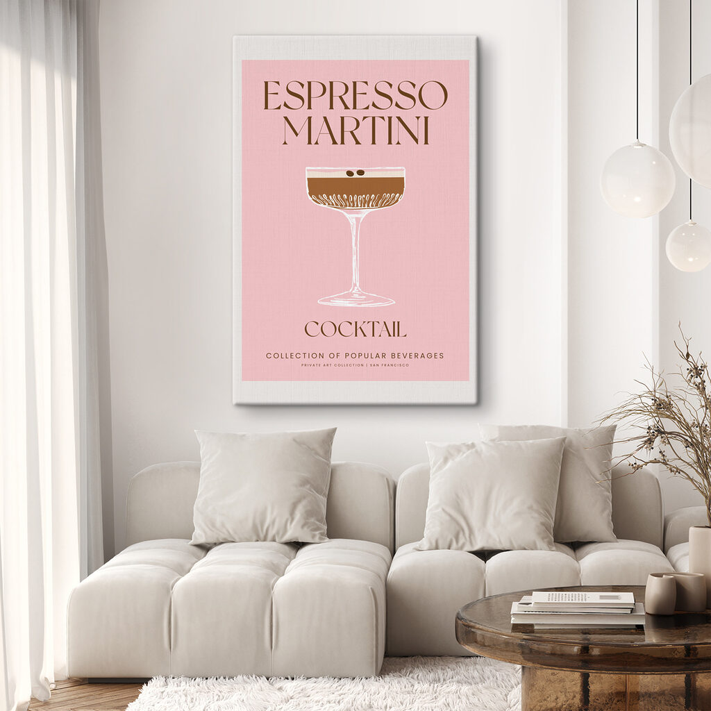 A pink and white sign with a glass of brown liquid